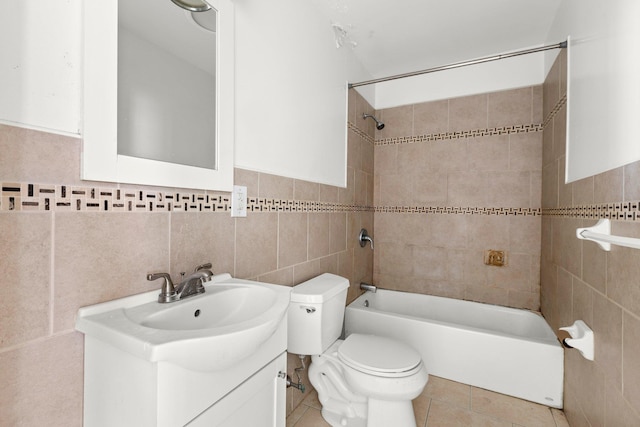 full bath featuring vanity, shower / bathing tub combination, tile walls, toilet, and tile patterned floors