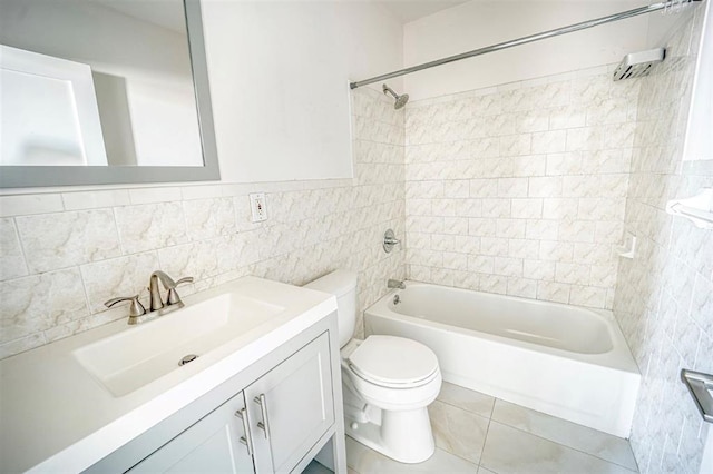 full bathroom with vanity, toilet, tile walls, and washtub / shower combination