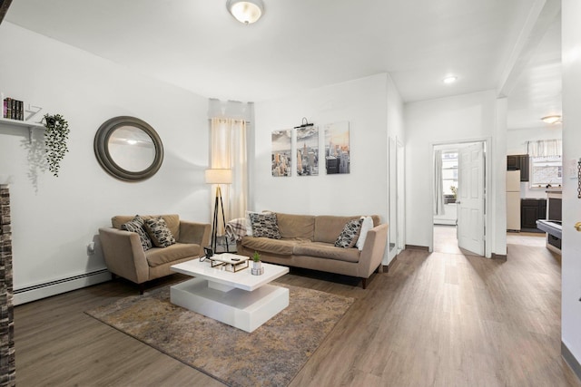 living area with wood finished floors and a baseboard radiator