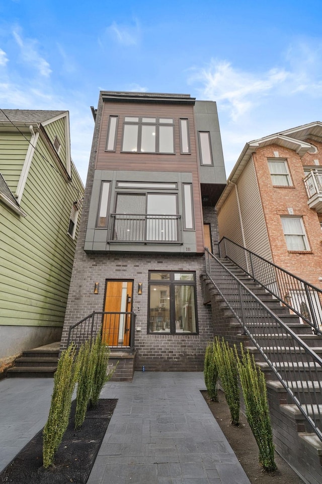 view of front facade featuring a patio and a balcony