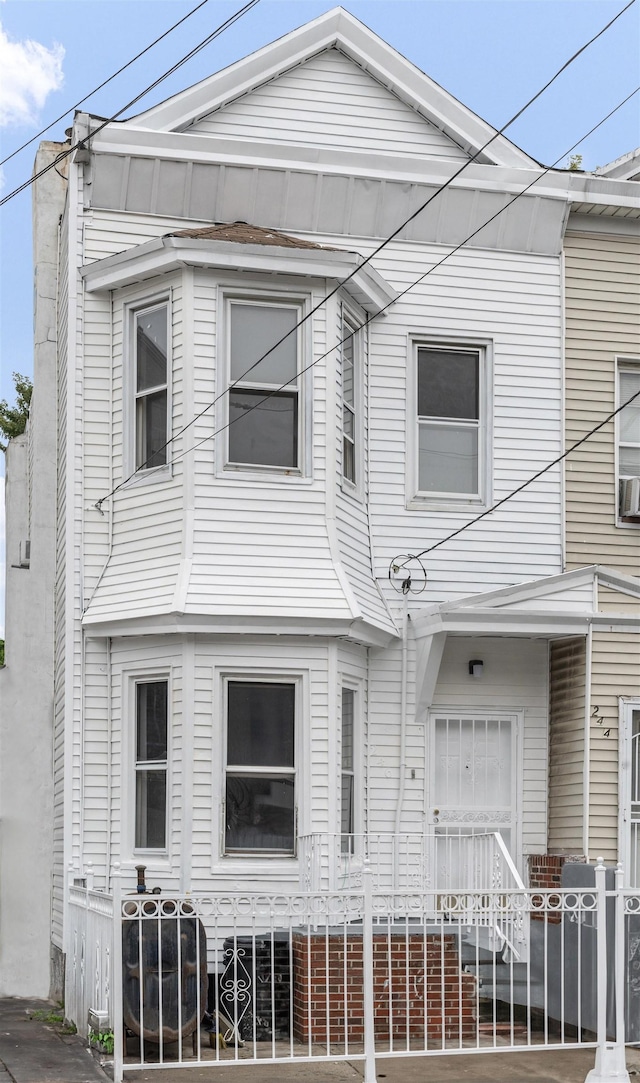 view of front of home featuring fence