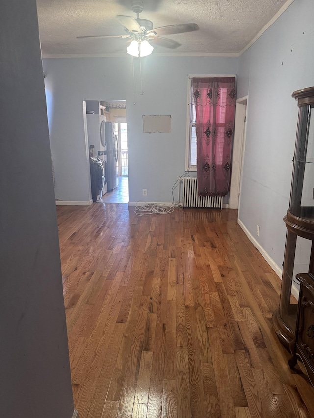 interior space featuring hardwood / wood-style floors, crown molding, ceiling fan, a textured ceiling, and radiator heating unit