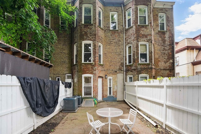 52 Brinkerhoff St, Jersey City, NJ 07304 - rear view of property with brick siding, a patio, and a fenced backyard