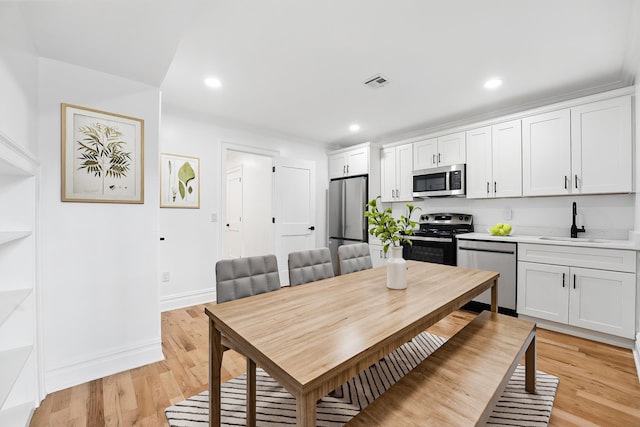 52 Brinkerhoff St, Jersey City, NJ 07304 - dining room with light wood finished floors, ornamental molding, and recessed lighting