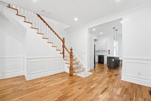 52 Brinkerhoff St, Jersey City, NJ 07304 - foyer featuring light wood-type flooring, stairway, recessed lighting, a decorative wall, and crown molding