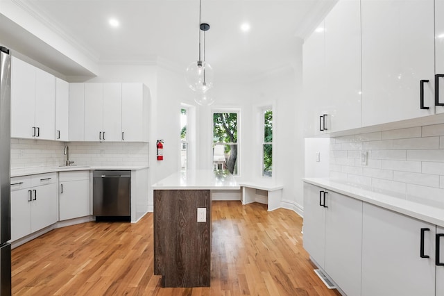 52 Brinkerhoff St, Jersey City, NJ 07304 - kitchen featuring dishwasher, light countertops, ornamental molding, light wood-type flooring, and recessed lighting