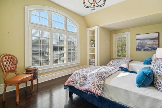 bedroom featuring an inviting chandelier, baseboards, visible vents, and dark wood-style flooring