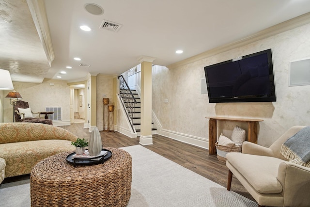 living area with visible vents, dark wood finished floors, and ornamental molding