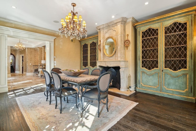 dining room with ornamental molding, dark wood finished floors, a notable chandelier, and recessed lighting