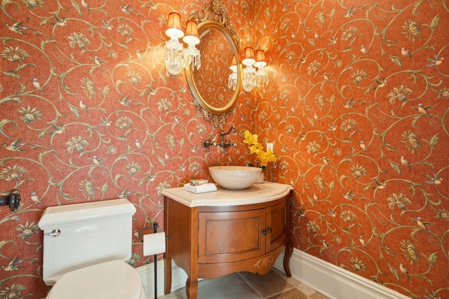 half bath with tile patterned flooring, baseboards, toilet, and wallpapered walls