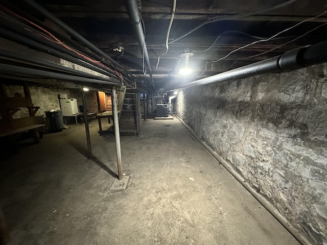 unfinished basement featuring water heater