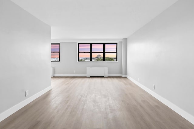 1225 Kennedy Blvd Unit 5A, Bayonne, NJ 07002 - unfurnished room with light wood-style flooring, baseboards, and radiator heating unit