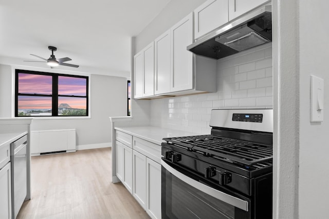 1225 Kennedy Blvd Unit 5A, Bayonne, NJ 07002 - kitchen featuring appliances with stainless steel finishes, extractor fan, backsplash, light countertops, and light wood finished floors