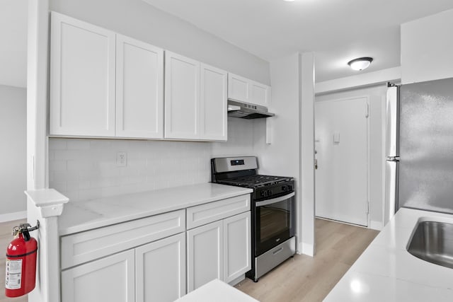 1225 Kennedy Blvd Unit 5A, Bayonne, NJ 07002 - kitchen with appliances with stainless steel finishes, under cabinet range hood, light wood-style flooring, and white cabinets