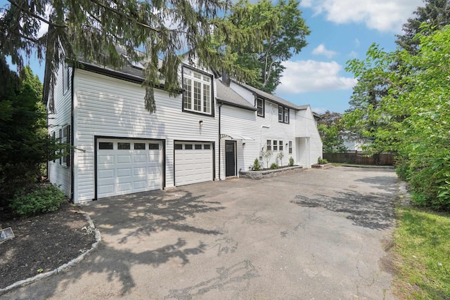 24 Tuers Pl, Montclair, NJ 07043 - view of side of home with asphalt driveway and an attached garage