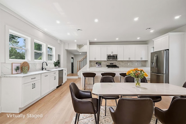 24 Tuers Pl, Montclair, NJ 07043 - dining room featuring light wood finished floors, recessed lighting, and stairway