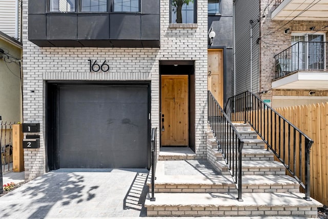 166 New York Ave, Jersey City, NJ 07307 - view of exterior entry with brick siding and an attached garage
