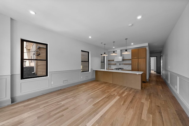 166 New York Ave, Jersey City, NJ 07307 - kitchen with light countertops, a peninsula, recessed lighting, open shelves, and a decorative wall
