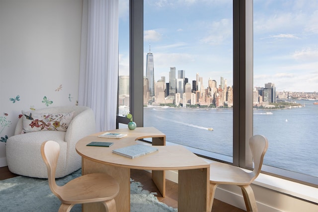 dining room with a water view and hardwood / wood-style flooring