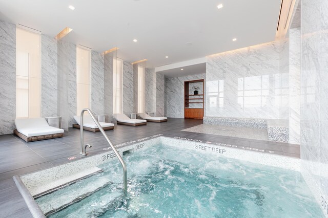 view of pool featuring an indoor hot tub