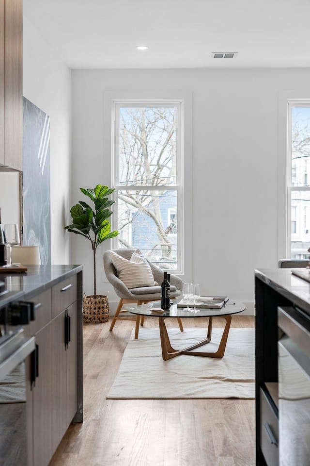 interior space featuring light wood-style floors and visible vents