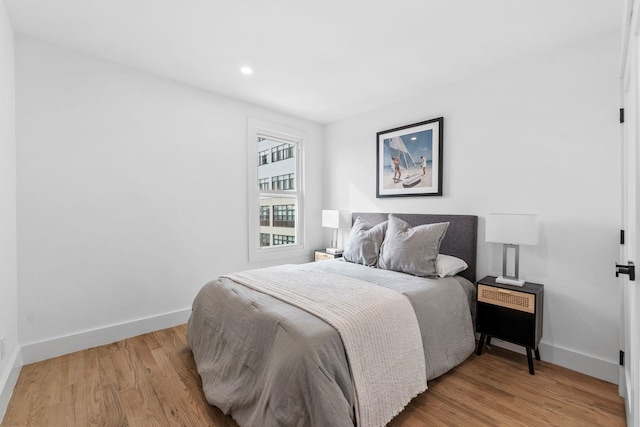 bedroom with recessed lighting, light wood-style flooring, and baseboards