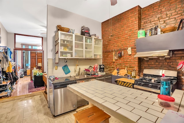 kitchen with dishwasher, decorative backsplash, sink, gas stove, and extractor fan