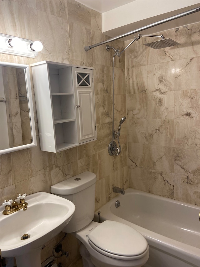 full bathroom featuring toilet, tile walls, tiled shower / bath, sink, and tasteful backsplash