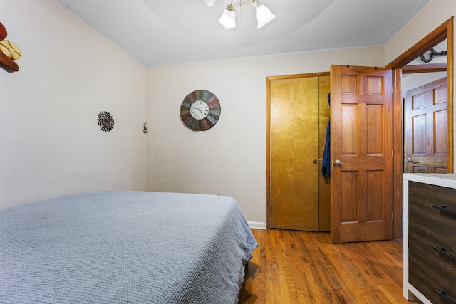 bedroom featuring a ceiling fan and wood finished floors