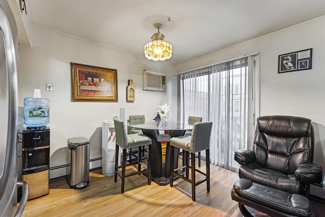 dining space with baseboard heating and wood finished floors