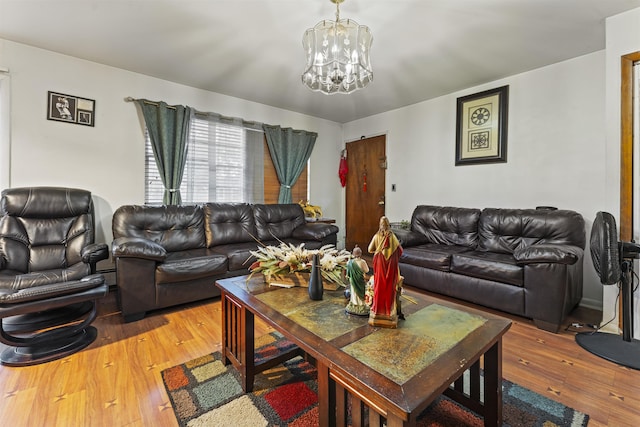 living area featuring light wood-style floors and a notable chandelier