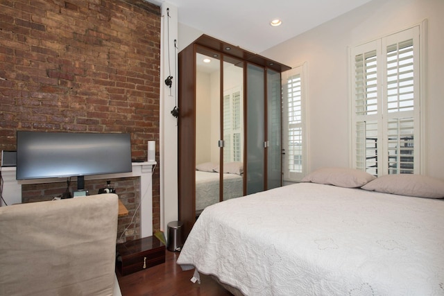 bedroom with dark hardwood / wood-style flooring