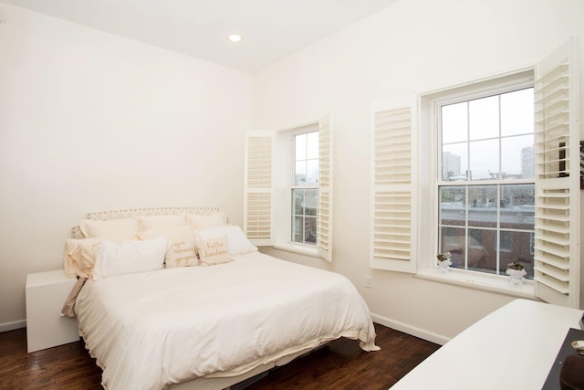 bedroom with dark wood-type flooring