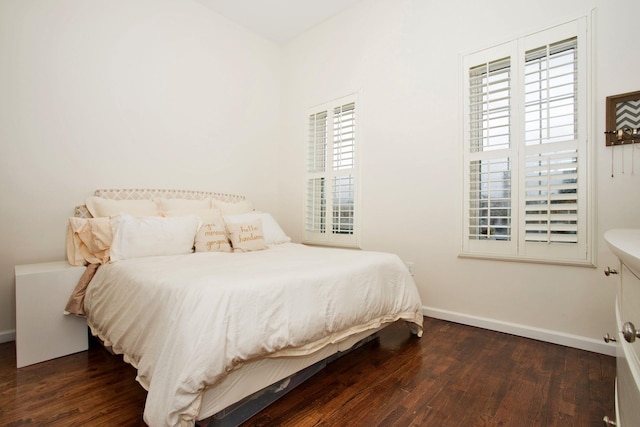 bedroom with dark wood-type flooring