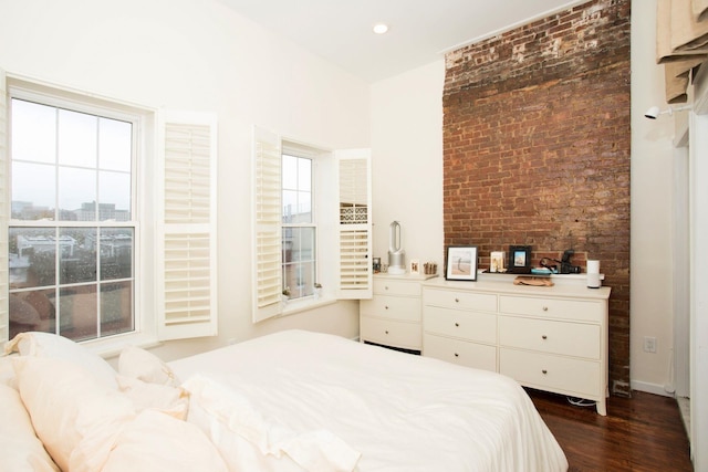 bedroom with dark hardwood / wood-style floors and multiple windows