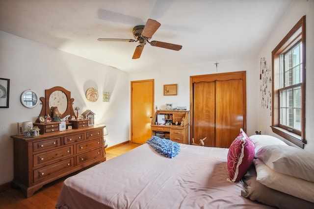 bedroom featuring a ceiling fan and wood finished floors