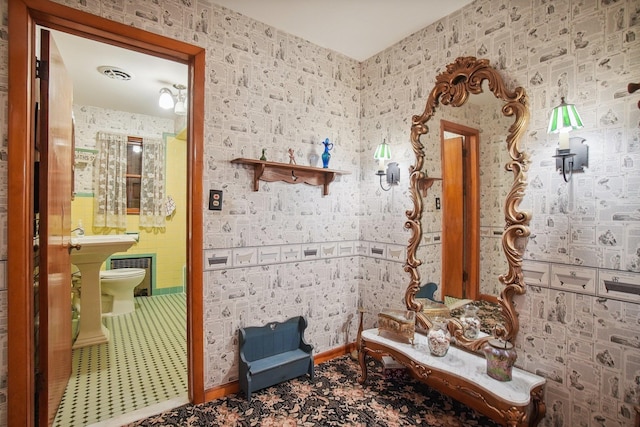 bathroom with toilet, baseboards, and visible vents