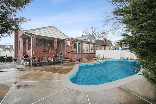 view of swimming pool with a patio, a fenced in pool, and a fenced backyard