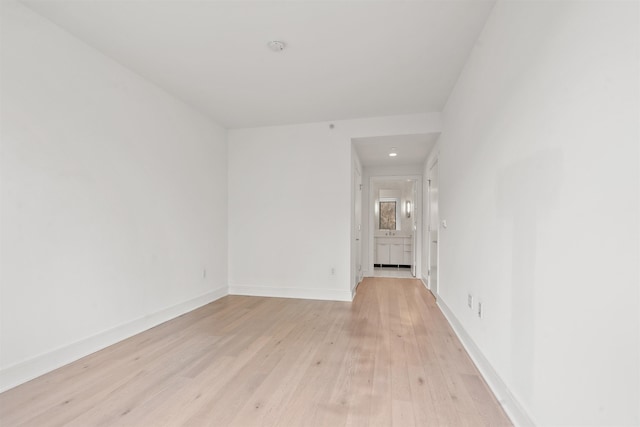 unfurnished room with light wood-type flooring