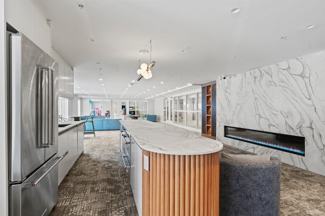 20 Avenue At Port Imperial Unit 217, West New York, NJ 07093 - kitchen with high quality fridge, modern cabinets, open floor plan, and a high end fireplace