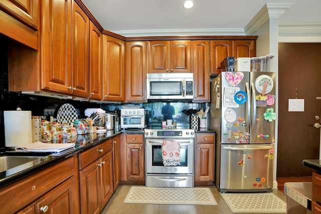 20 Avenue At Port Imperial Unit 217, West New York, NJ 07093 - kitchen with stainless steel appliances, crown molding, brown cabinetry, tasteful backsplash, and dark stone counters