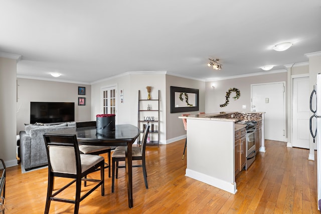 100 Manhattan Ave Unit 407, Union City, NJ 07087 - kitchen with stainless steel range, light wood-style flooring, ornamental molding, and a center island