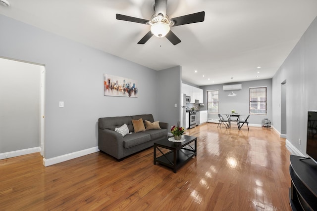 living room featuring hardwood / wood-style floors and ceiling fan