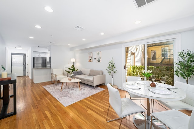 living room with light wood finished floors and recessed lighting