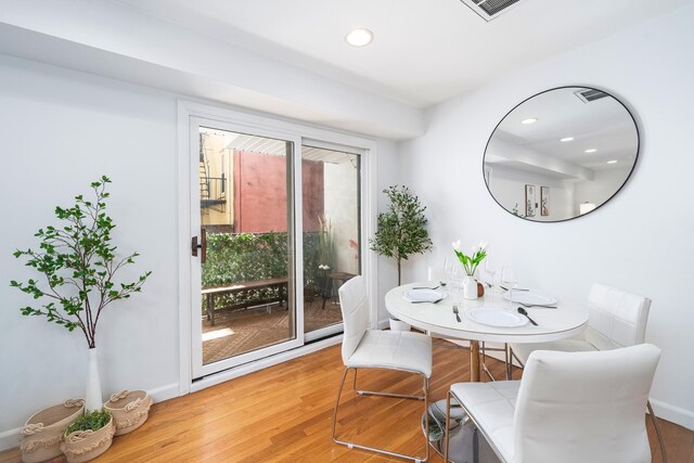 dining space with light wood-style floors, recessed lighting, and baseboards