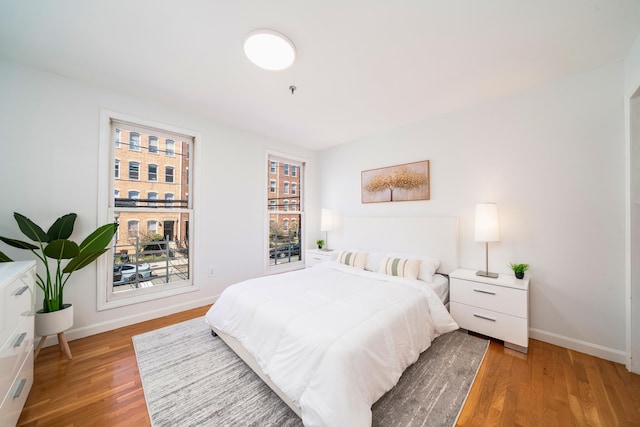 bedroom with wood finished floors and baseboards