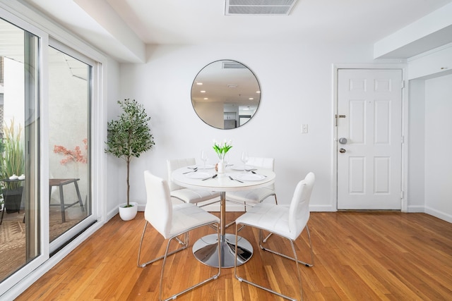 dining area with light wood finished floors and baseboards