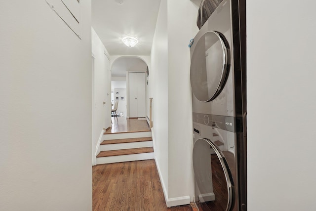 48 W Hamilton Pl Unit 5, Jersey City, NJ 07302 - washroom featuring estacked washer and dryer, arched walkways, and wood finished floors