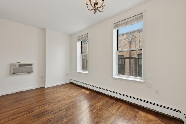 48 W Hamilton Pl Unit 5, Jersey City, NJ 07302 - unfurnished room featuring a baseboard heating unit, an AC wall unit, a chandelier, and wood finished floors