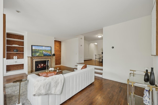 48 W Hamilton Pl Unit 5, Jersey City, NJ 07302 - living room featuring dark wood finished floors, a glass covered fireplace, a baseboard heating unit, and built in shelves